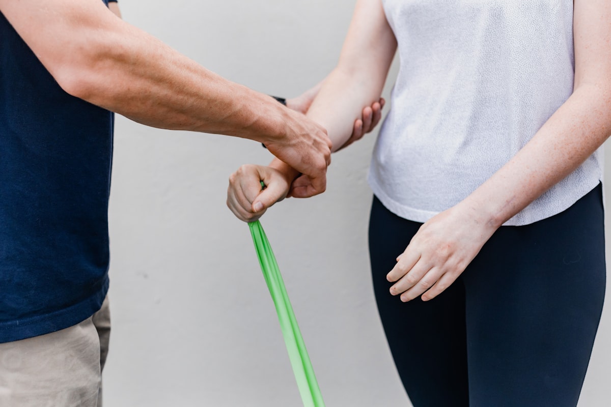 Professional rehabilitation specialist guiding patient through movement exercises
